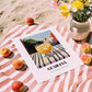 Guaraná – Brazilian Street Café Scene, Brazilian Beverage Wall Decor, unframed on coastal sand