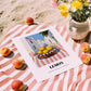Lemon – White village Street Café Scene, Fruit Wall Decor, unframed on coastal sand
